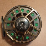 Aikelen ZF-102 Fly Reel Pre-spooled W/ Line Gray/gold/green. Fixed Price $200.00.