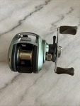 Preowned Shakespeare Axiom AX2LP Baitcasting Fishing Reel Good Used Condition. Fixed Price $20.00.