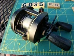 V6035 Ar Ryobi Vmag 4V Touch Trip Baitcaster Fishing Reel. Fixed Price $35.00.