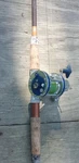 Vintage Olympic Dolphin No# 621-LW Fishing Reel On Pole 78". Fixed Price $90.00.