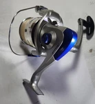 Shakespeare Surf And Pier SP50A Silver Blue Spinning Reel. Fixed Price $25.00.