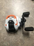 Zebco Bait Casting Reel ( Orange And White ) Model ROAMOR100S. Fixed Price $18.95.