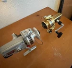 Vtg Daiwa 1500C Silver Zebco 6010 Gold Fishing Reels. Fixed Price $30.00.