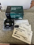 Shimano Curado (CU-50E) Casting Reel 6.4:1 Right-hand Baitcaster W/ Box. Fixed Price $399.95.