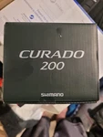 Shimano Curado Baitcast Reel CU200M. Fixed Price $225.00.