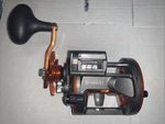 Sougayilang, Line Counting Trolling Reel, Orange, Left Hand. Fixed Price $45.00.