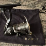 Daiwa Exist 2004 Black/silver Spinning Reel 4.1:1 12BB Front Drag W/ Pouch. Fixed Price $395.05.